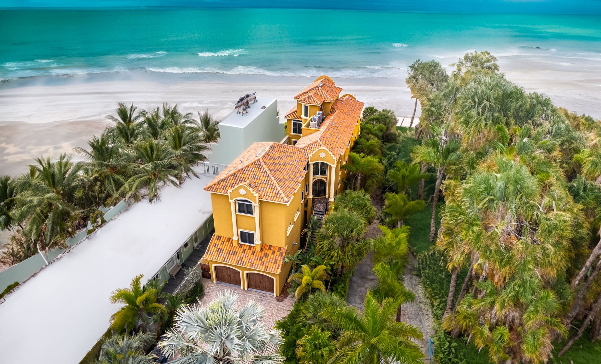 Luxury beachfront Clearwater Beach vacation rental home with ocean views and palm trees