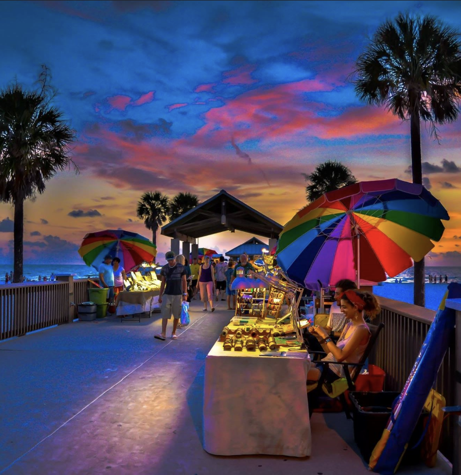 Vibrant sunset over Pier 60 market stalls at Clearwater Beach, Florida.