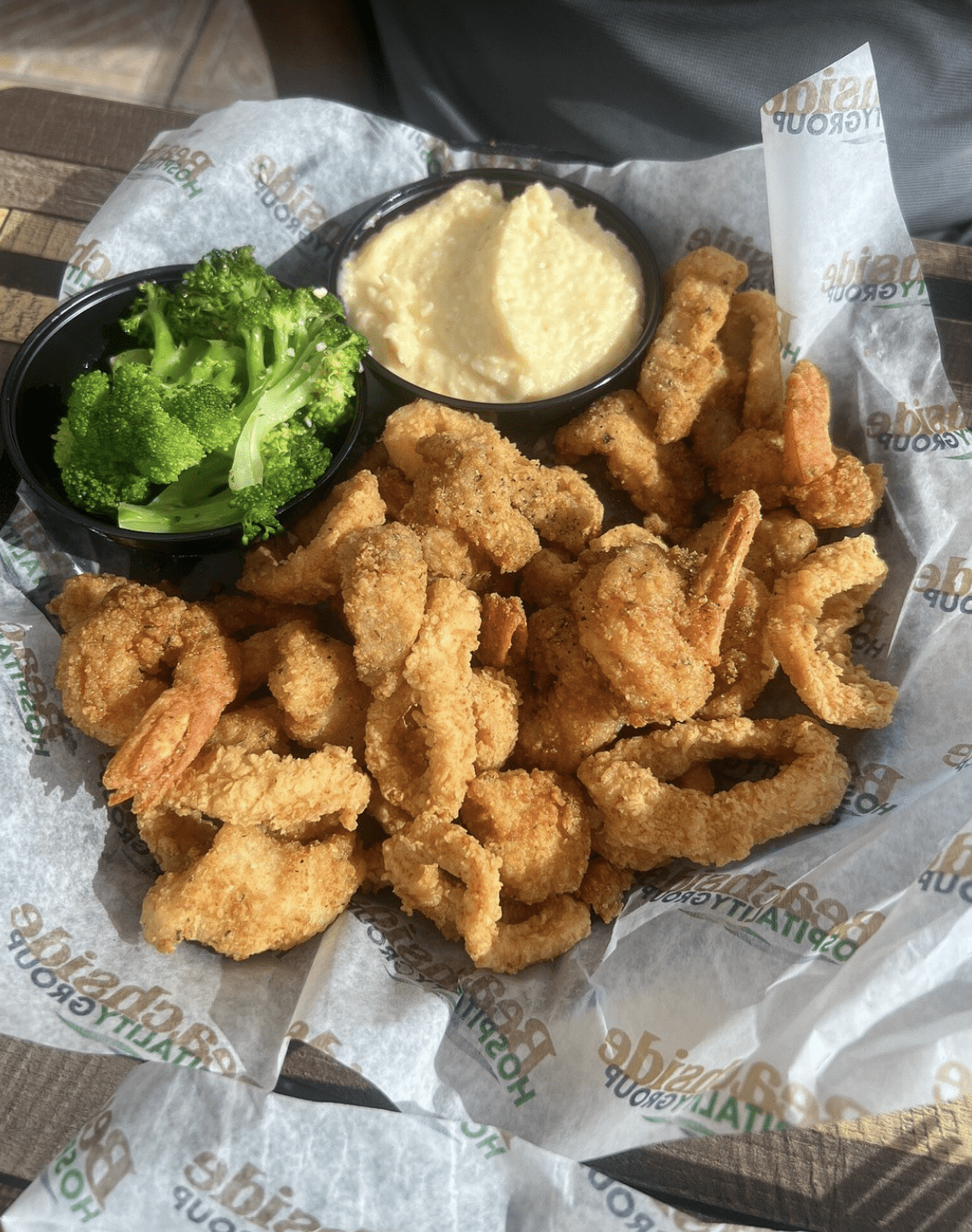 Crispy fried shrimp and calamari served with broccoli and creamy grits.